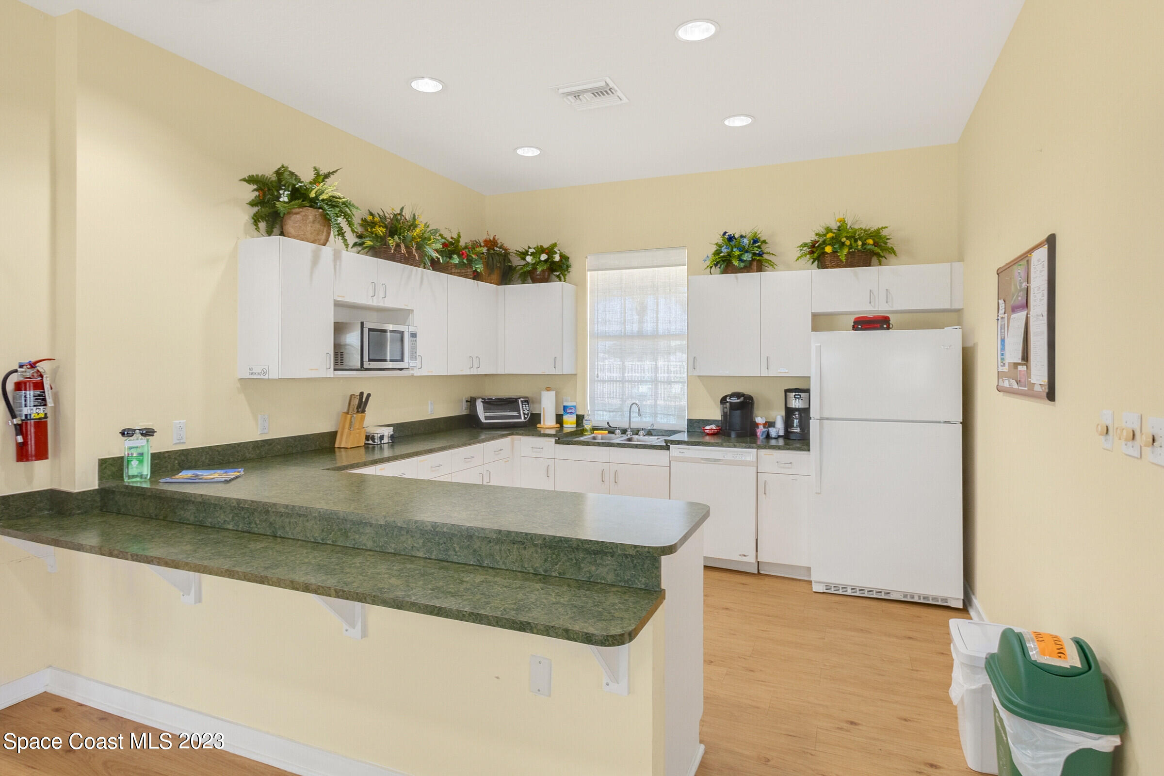 4100 Alamanda Key Drive Melbourne, FL 32901 - Photo 43 of 73 a white refrigerator freezer sitting inside of a kitchen