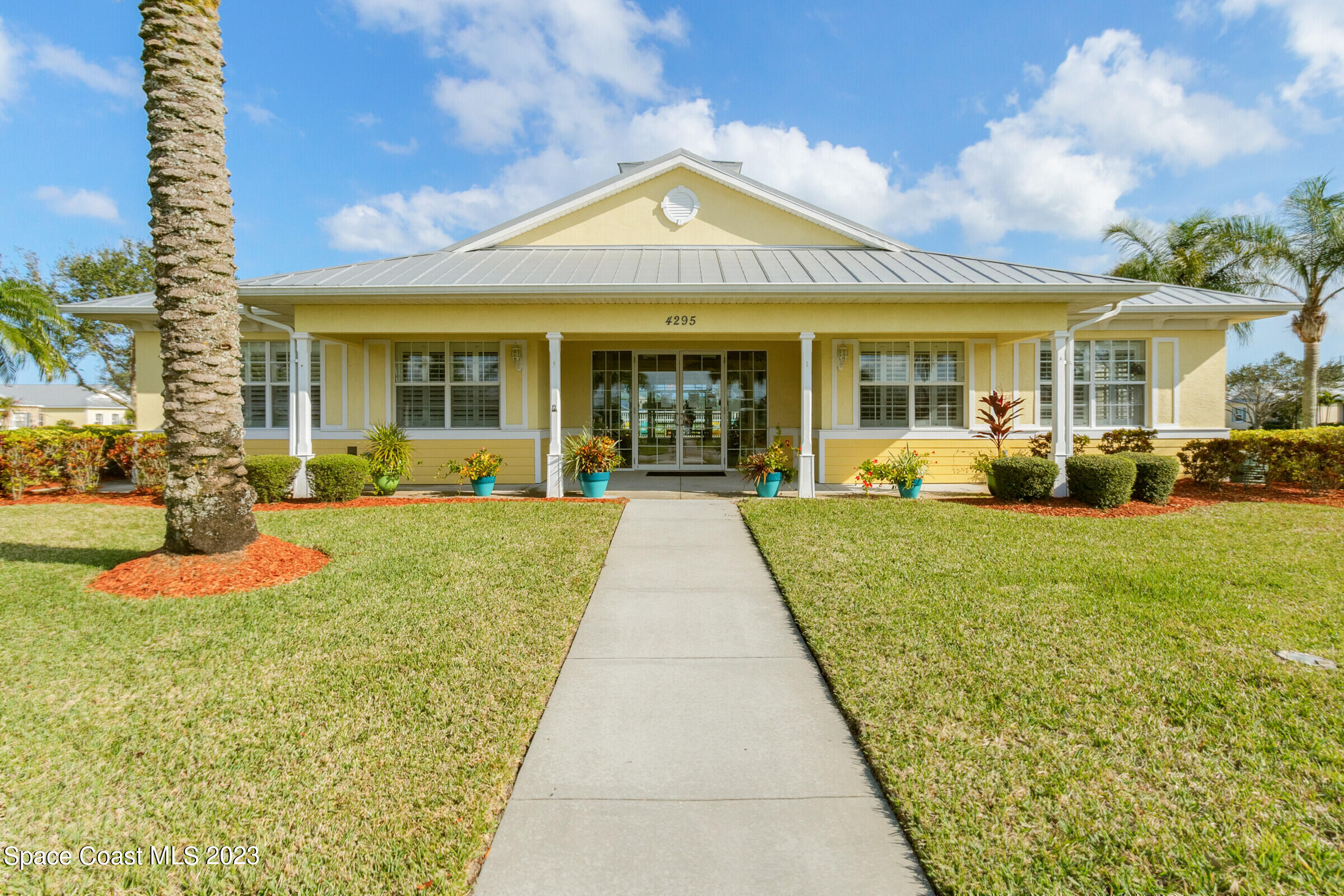 4100 Alamanda Key Drive Melbourne, FL 32901 - Photo 51 of 73 a view of a patio with couches chairs large with large trees