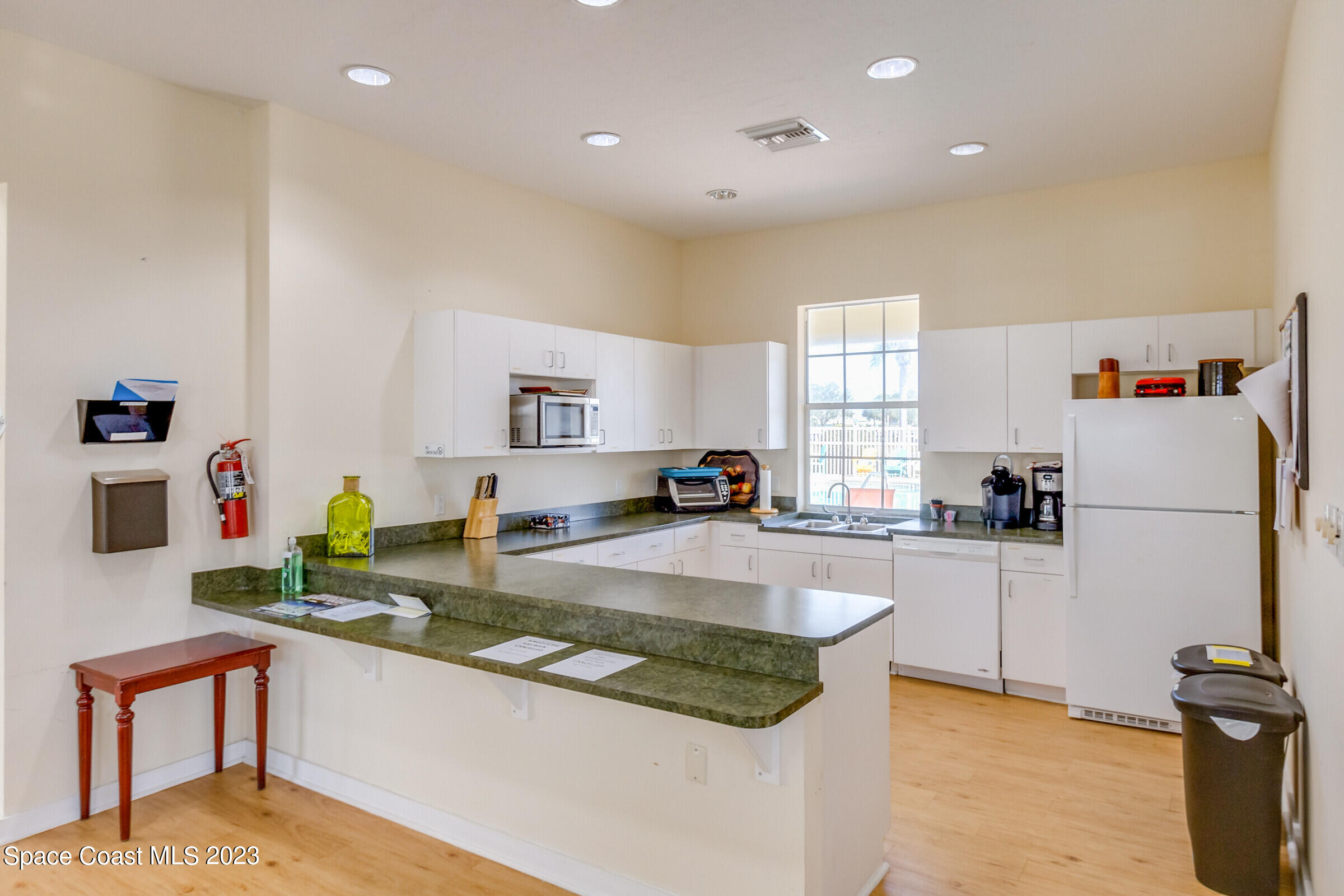 4100 Alamanda Key Drive Melbourne, FL 32901 - Photo 63 of 73 a kitchen with sink refrigerator and microwave