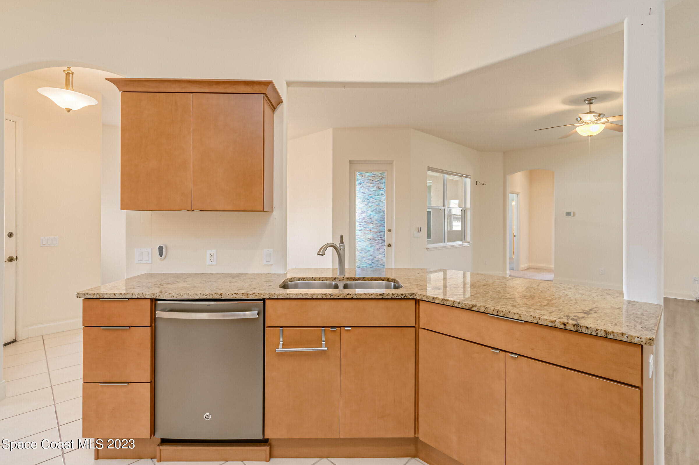 4100 Alamanda Key Drive Melbourne, FL 32901 - Photo 8 of 73 a kitchen with stainless steel appliances granite countertop a sink and cabinets with wooden floor