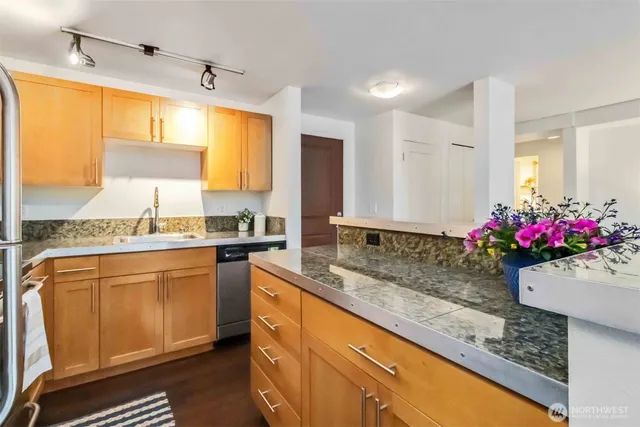 a kitchen with sink cabinets and granite counter top