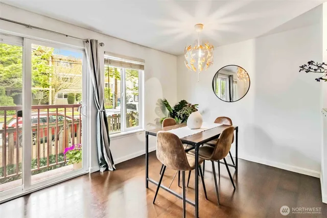 a view of a dining room with furniture window and wooden floor