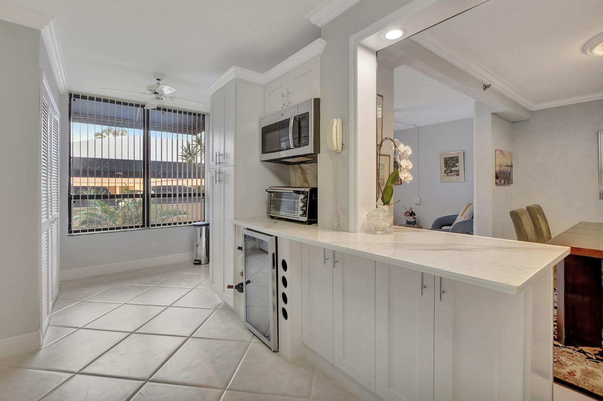 7194 Promenade Drive, Unit 102 Boca Raton, FL 33433 - Photo 16 of 56 a view of kitchen and windows
