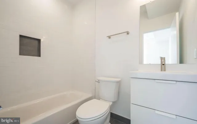 a kitchen with stainless steel appliances a sink a stove a refrigerator and cabinets