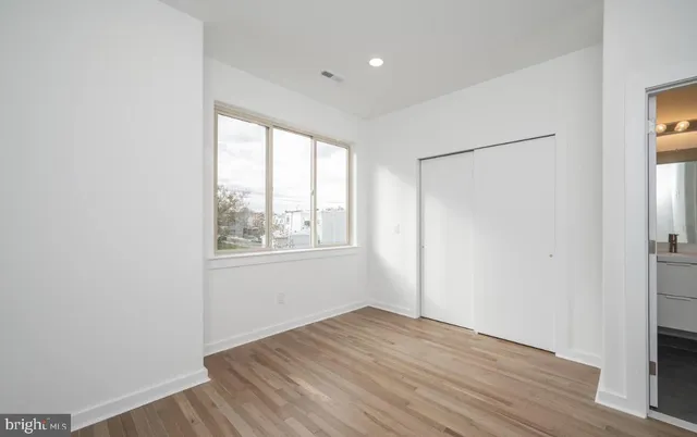 a kitchen with stainless steel appliances a refrigerator and a stove top oven