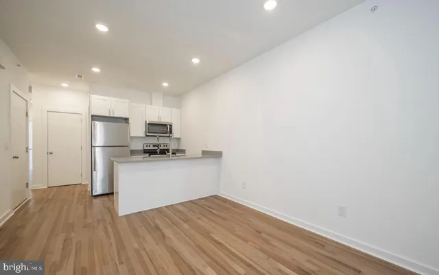 a kitchen with a refrigerator stove and microwave