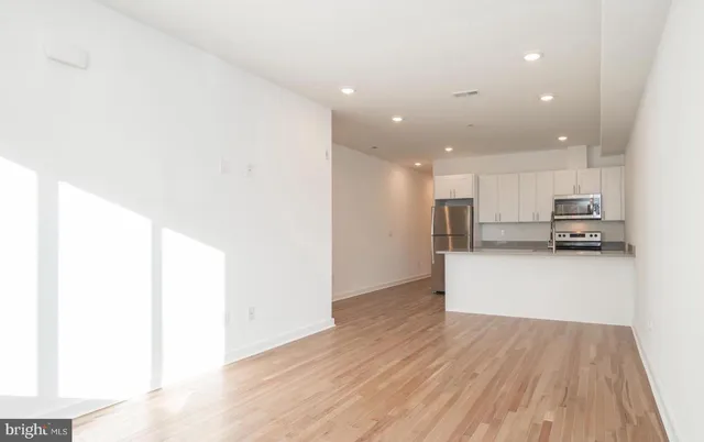 a view of kitchen and wooden floor