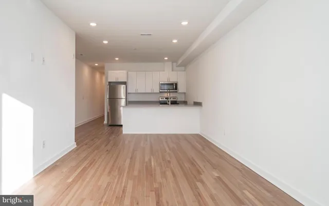 a kitchen with stainless steel appliances granite countertop a refrigerator sink and stove