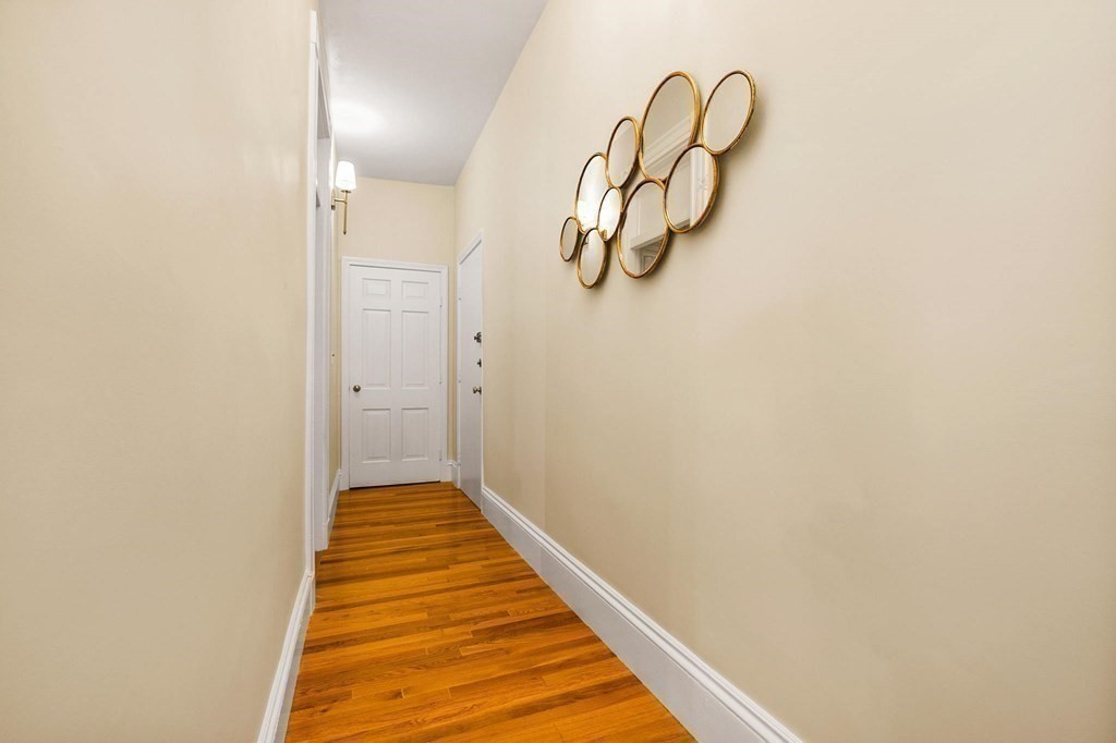 481 Beacon Street, Unit 43 Boston, MA 02115 - Photo 6 of 10 a view of a room with wooden floor and white walls