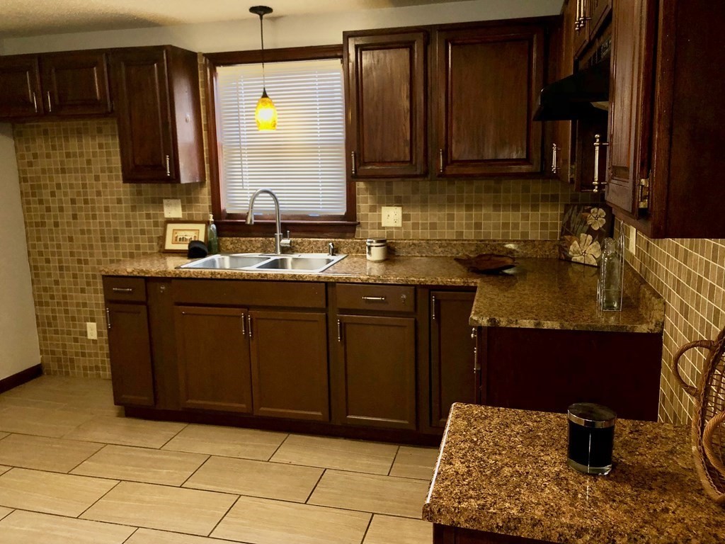 112 Stockman Street Springfield, MA 01104 - Photo 6 of 28 a kitchen with a sink and cabinets