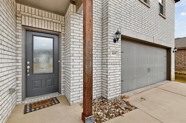 a view of a house with a door and wooden floor