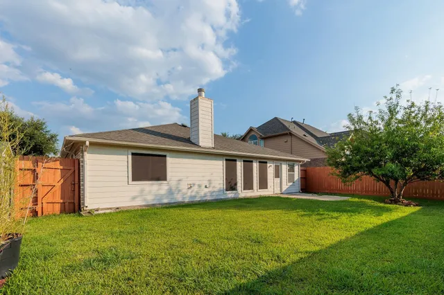 a front view of a house with a garden and yard