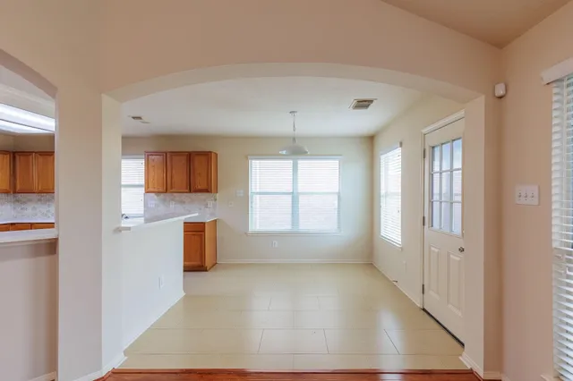 a view of a kitchen with wooden floor and a kitchen