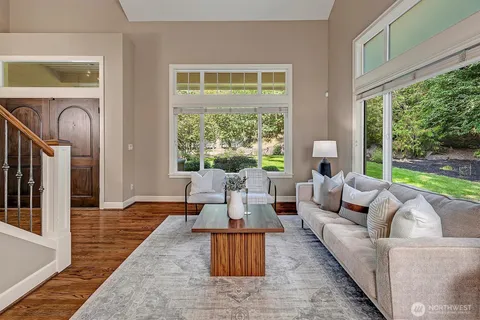 a living room with furniture and a floor to ceiling window