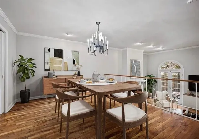 a view of a dining room with furniture and wooden floor