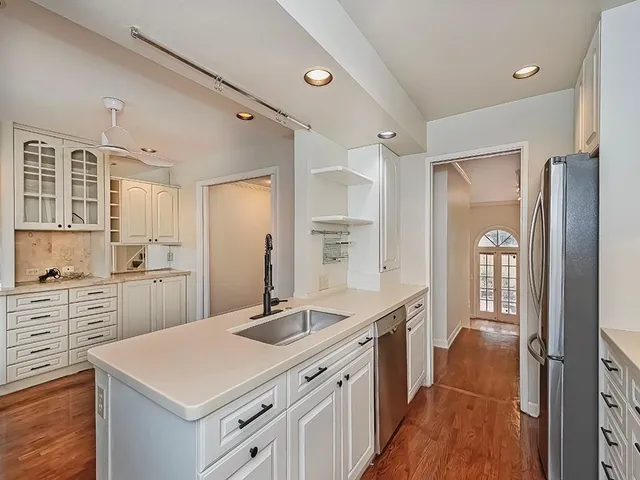 a kitchen with a sink stove and cabinets