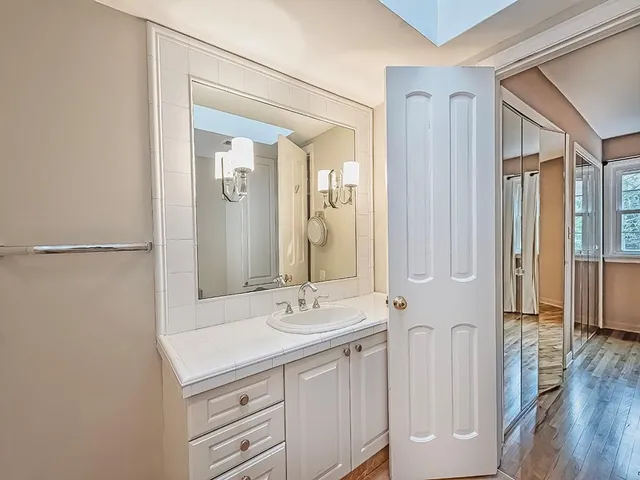 a bathroom with a double vanity sink a mirror and a shower