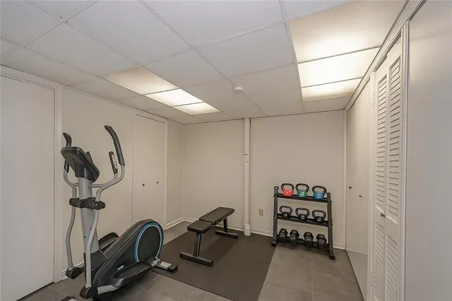 a room with gym equipment and a mirror