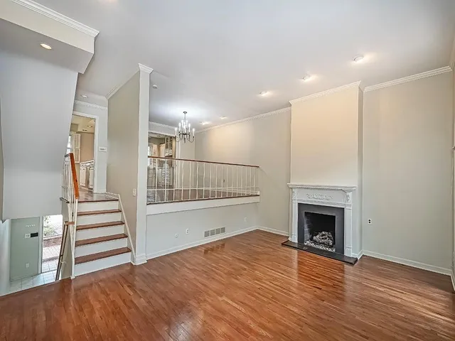 a view of a livingroom with wooden floor and fireplace