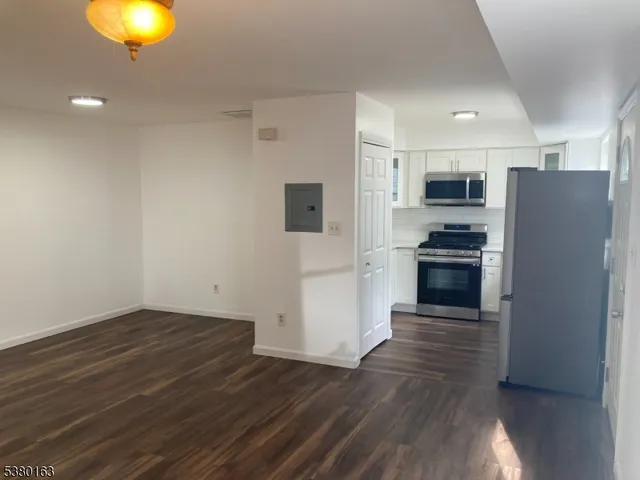 a kitchen with a refrigerator and a stove top oven