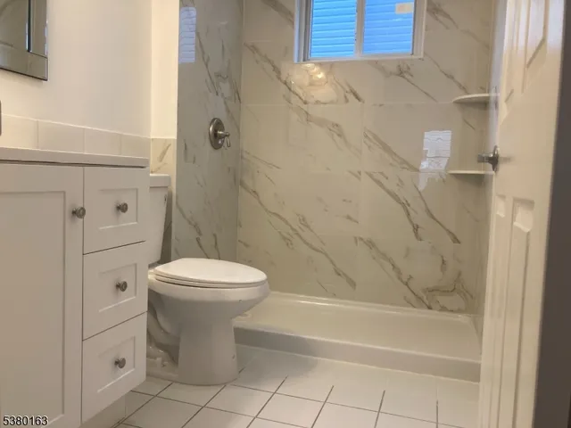 a bathroom with a toilet sink and shower