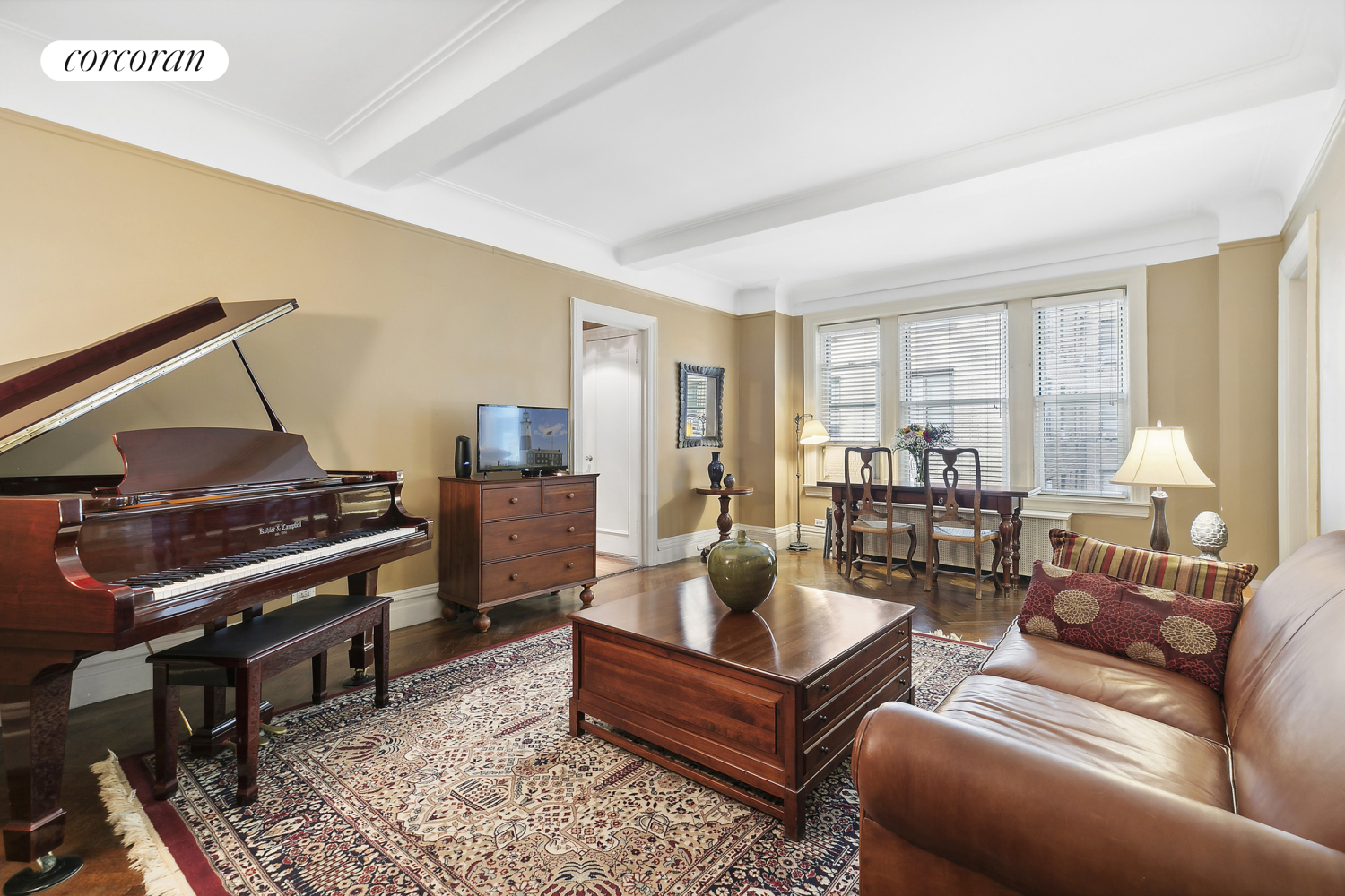 a living room with furniture and a piano