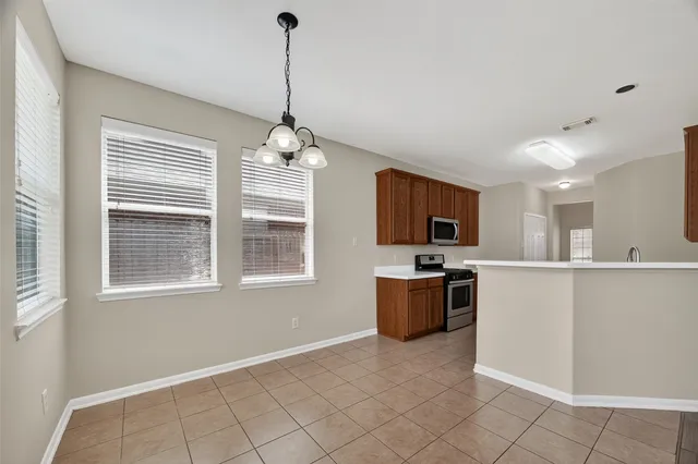a kitchen with stainless steel appliances granite countertop a refrigerator and microwave