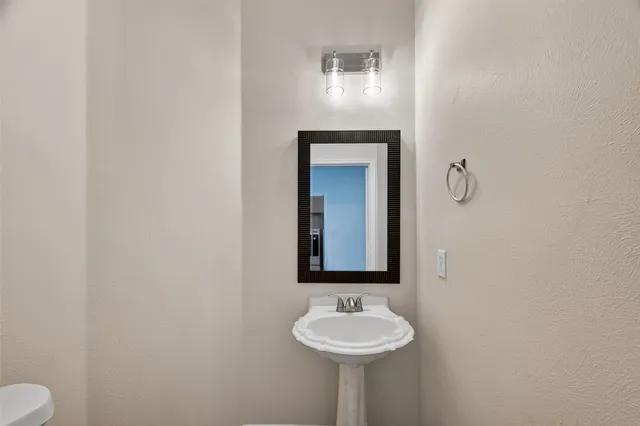 a bathroom with a sink and mirror