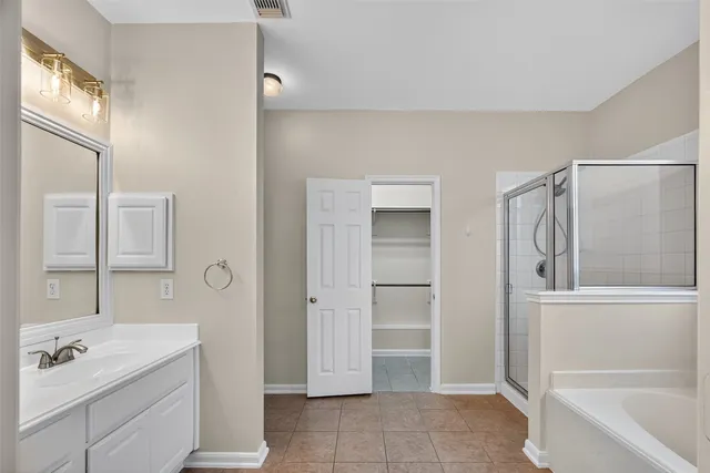 a bathroom with a tub sink and mirror
