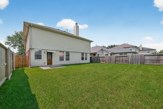 a view of a house with a backyard