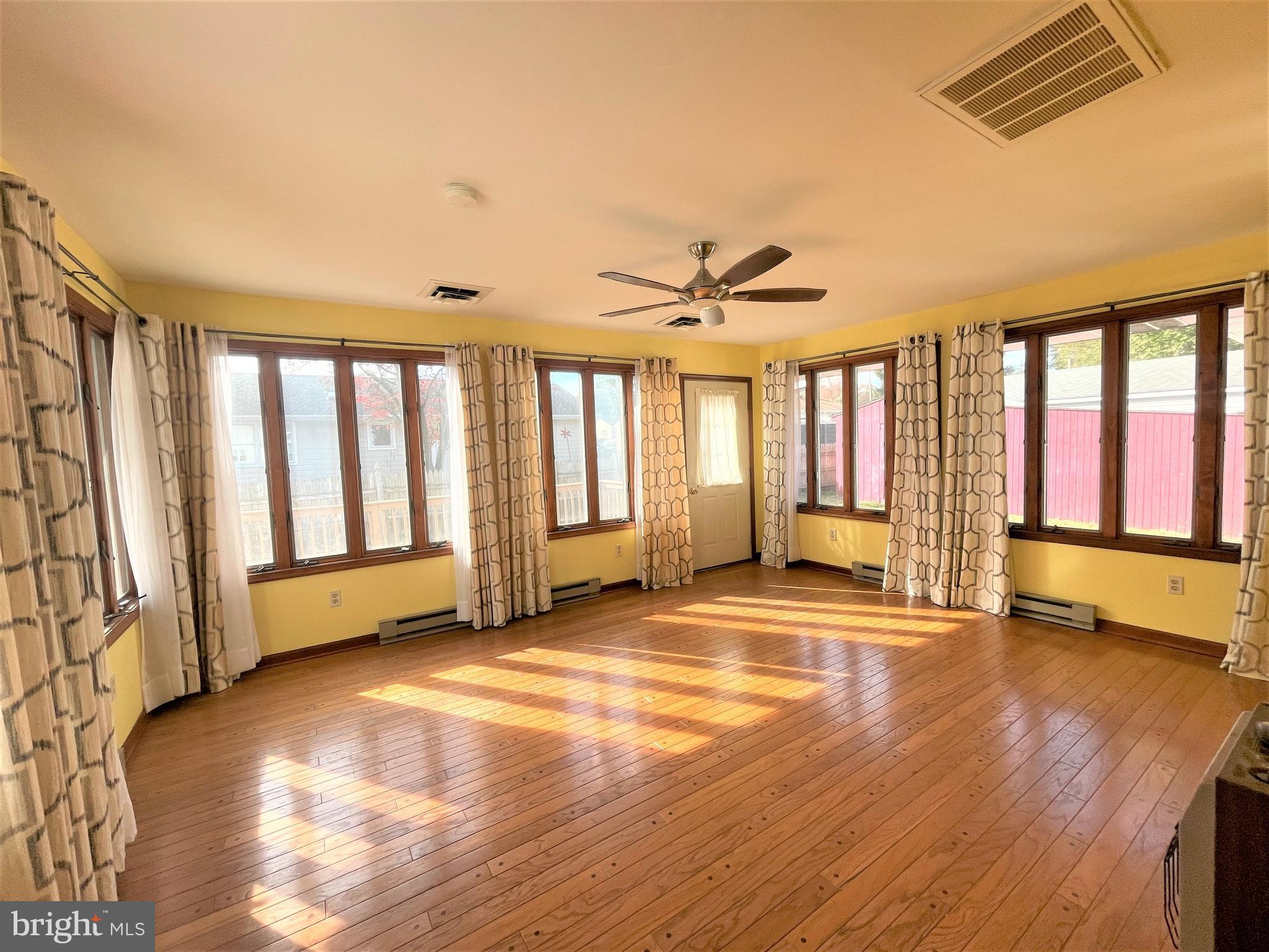 29 Georgia Road Pennsville, NJ 08070 - Photo 12 of 29 a view of an empty room with a window and wooden floor