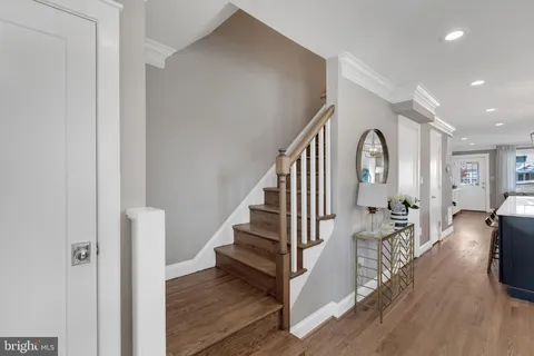 a view of entryway and hall with wooden floor