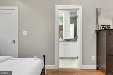 a bedroom with a bed and a mirror