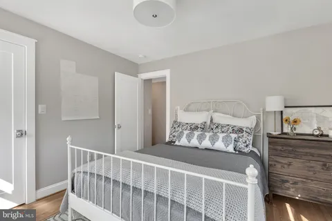 a bedroom with a bed dresser and a window