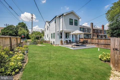 a view of a house with a yard porch and sitting area