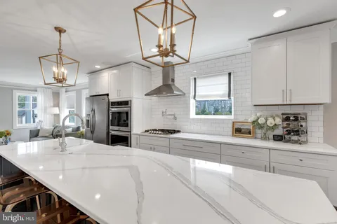 a kitchen with stainless steel appliances kitchen island granite countertop a sink and cabinets
