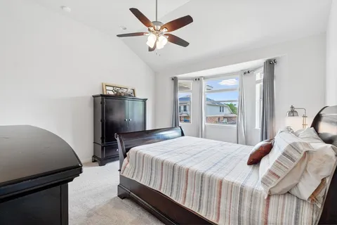 a bedroom with a bed and a refrigerator