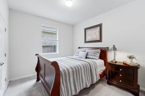 a bedroom with a bed and a window