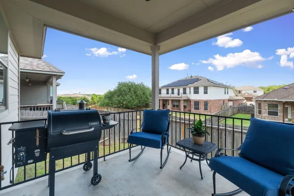 a view of a chair and tables in the balcony