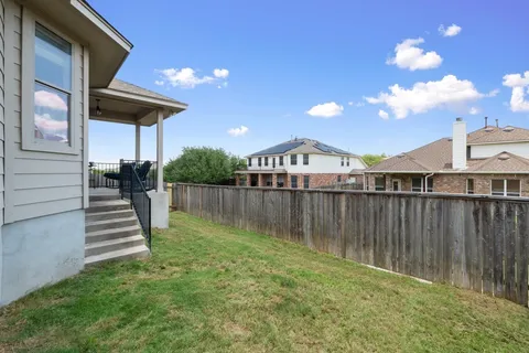 a view of a backyard with plants and lake view