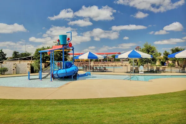 a childrens park with lots of swings and slides