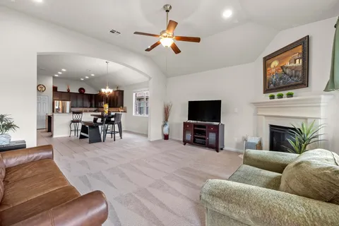a living room with furniture fireplace and flat screen tv