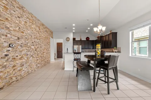 a view of a dining room with furniture and chandelier