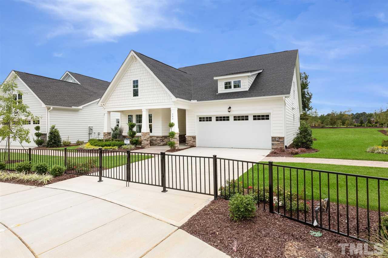 156 Ivory Lane, Unit 84 Raleigh, NC 27610 - Photo 2 of 30 a view of a white house with a small yard and plants
