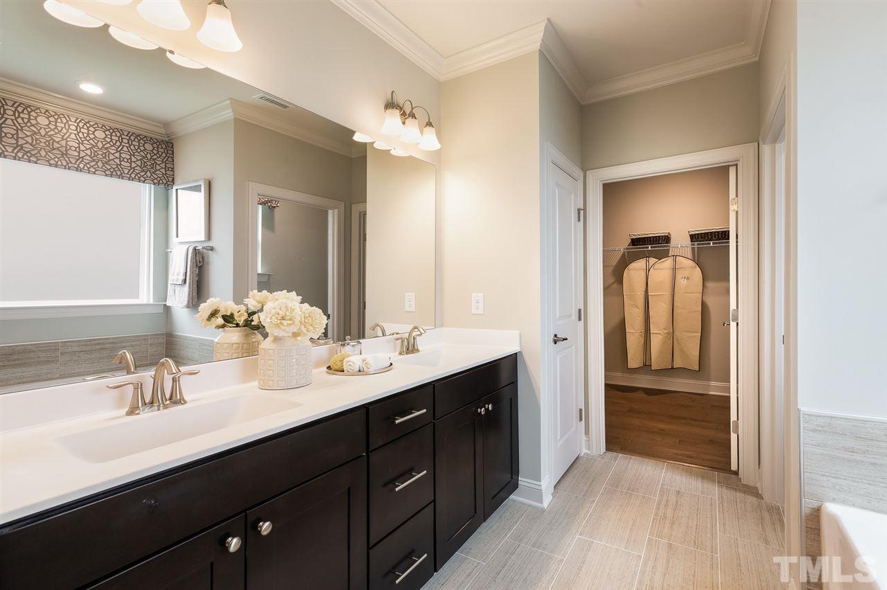 156 Ivory Lane, Unit 84 Raleigh, NC 27610 - Photo 20 of 30 a en suite bathroom with a double vanity sink a and a mirror