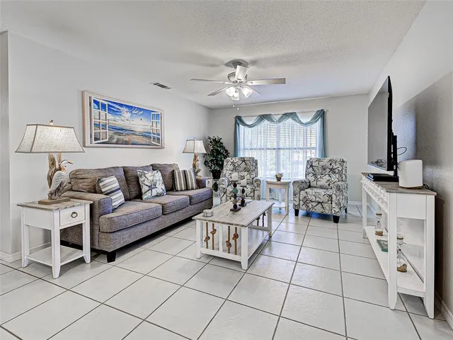 a living room with furniture a dining table and a painting on the wall