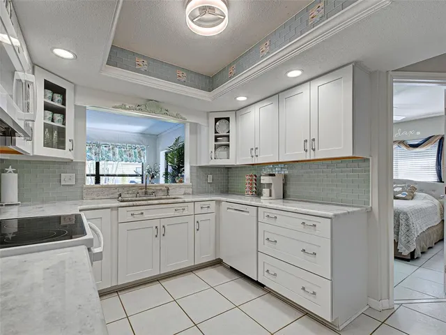 a room with kitchen island a bed and a dresser