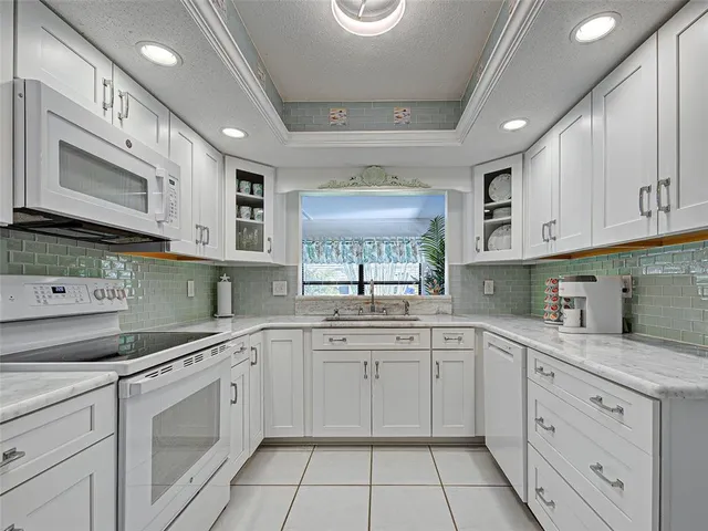 a kitchen with stainless steel appliances kitchen island granite countertop a sink and cabinets