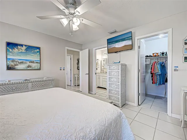a view of a dining room with furniture a chandelier and large windows