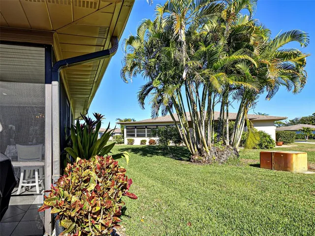 a living room with furniture and a lamp